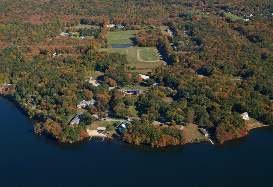 Aerial view of the St. Thomas More School campus beside the water